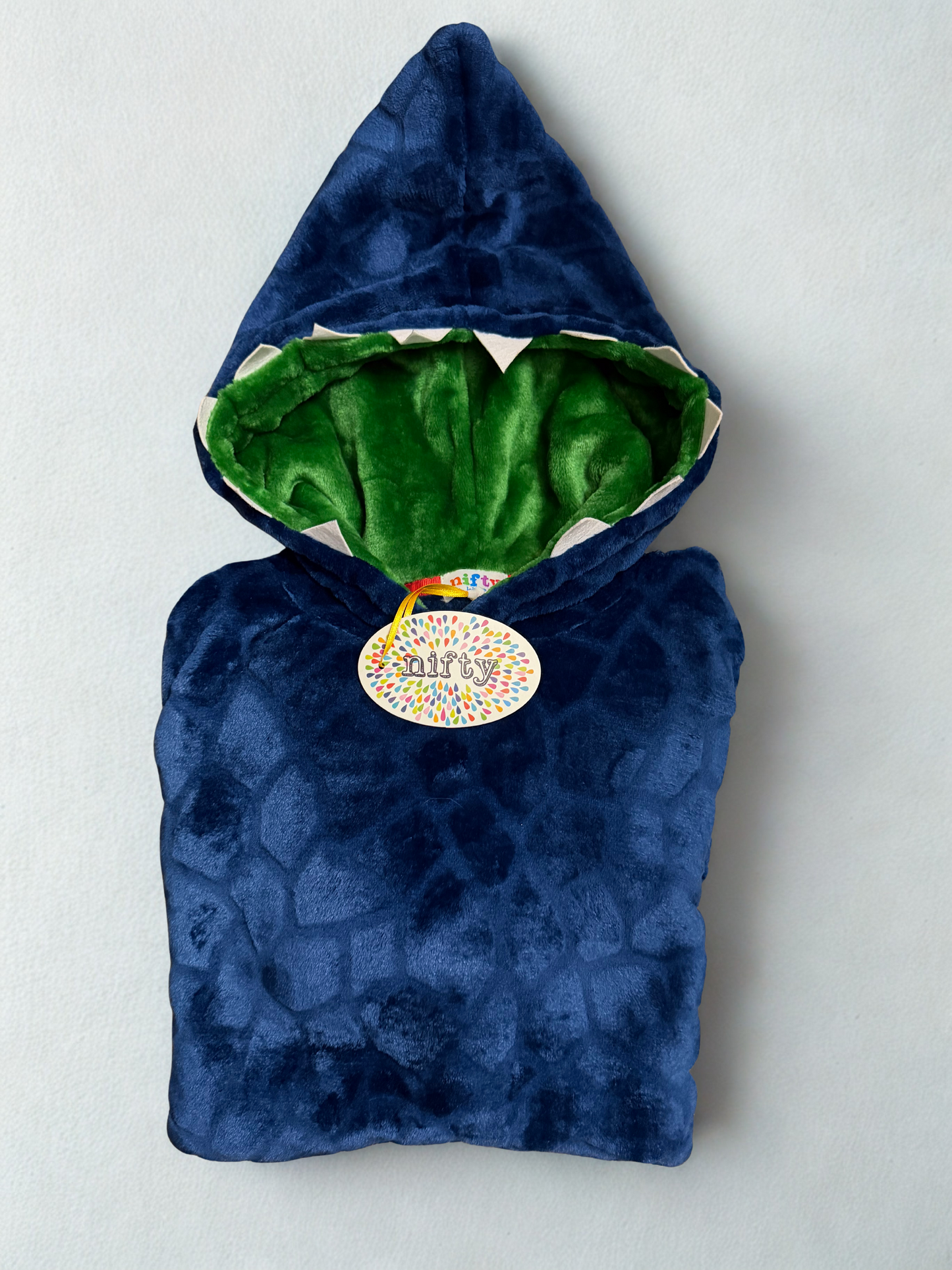 Blue shark-themed children's poncho with a green interior on a light gray background
